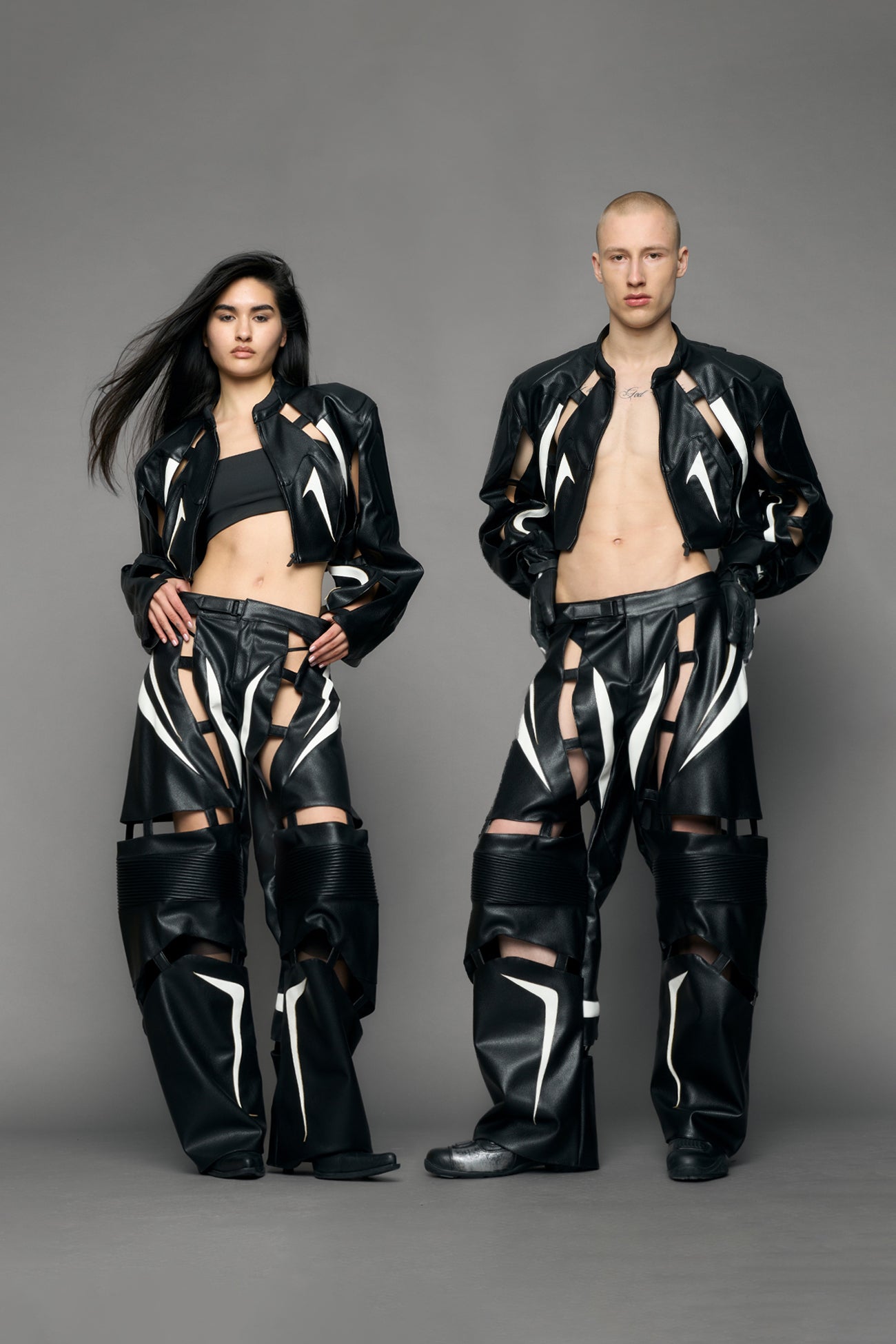 model wearing black and white pu leather pants with cut out details
