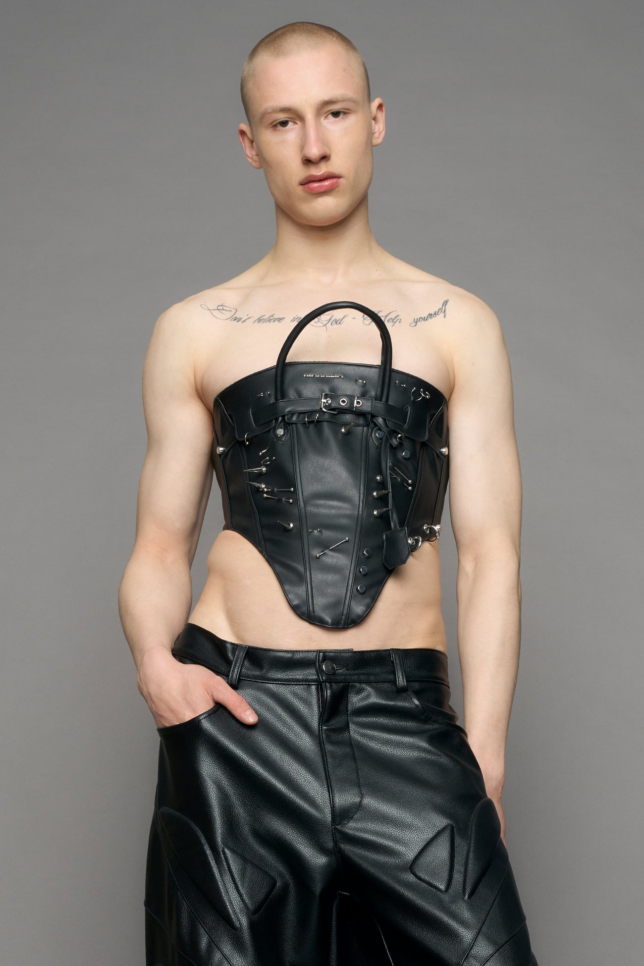 model wearing black studded handbag corset