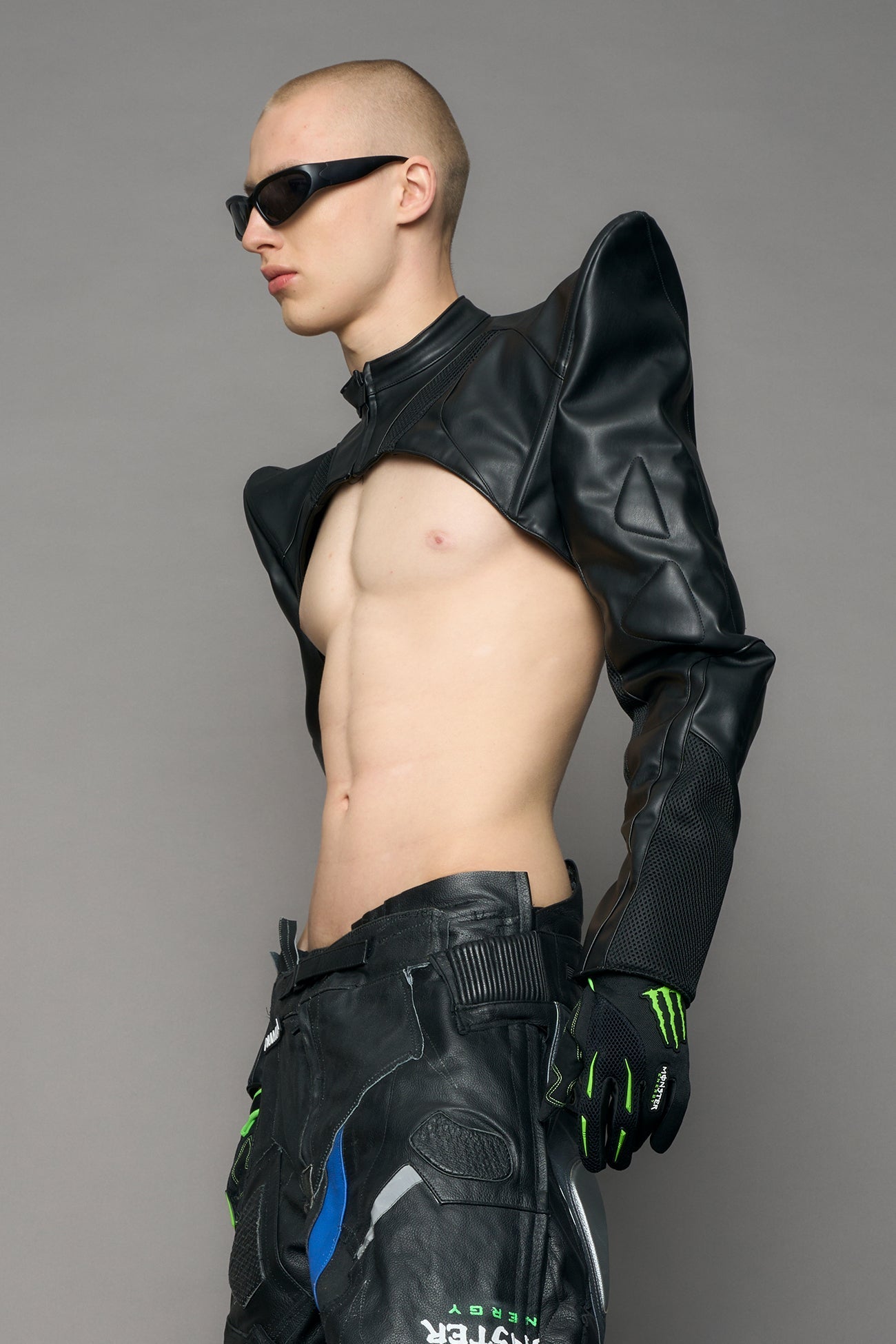 Model wearing a black leather choker jacket with cut-out design