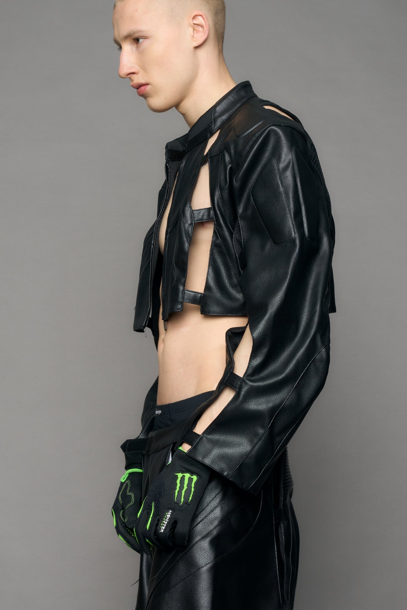 model wearing black moto pu leather jacket with cut out design