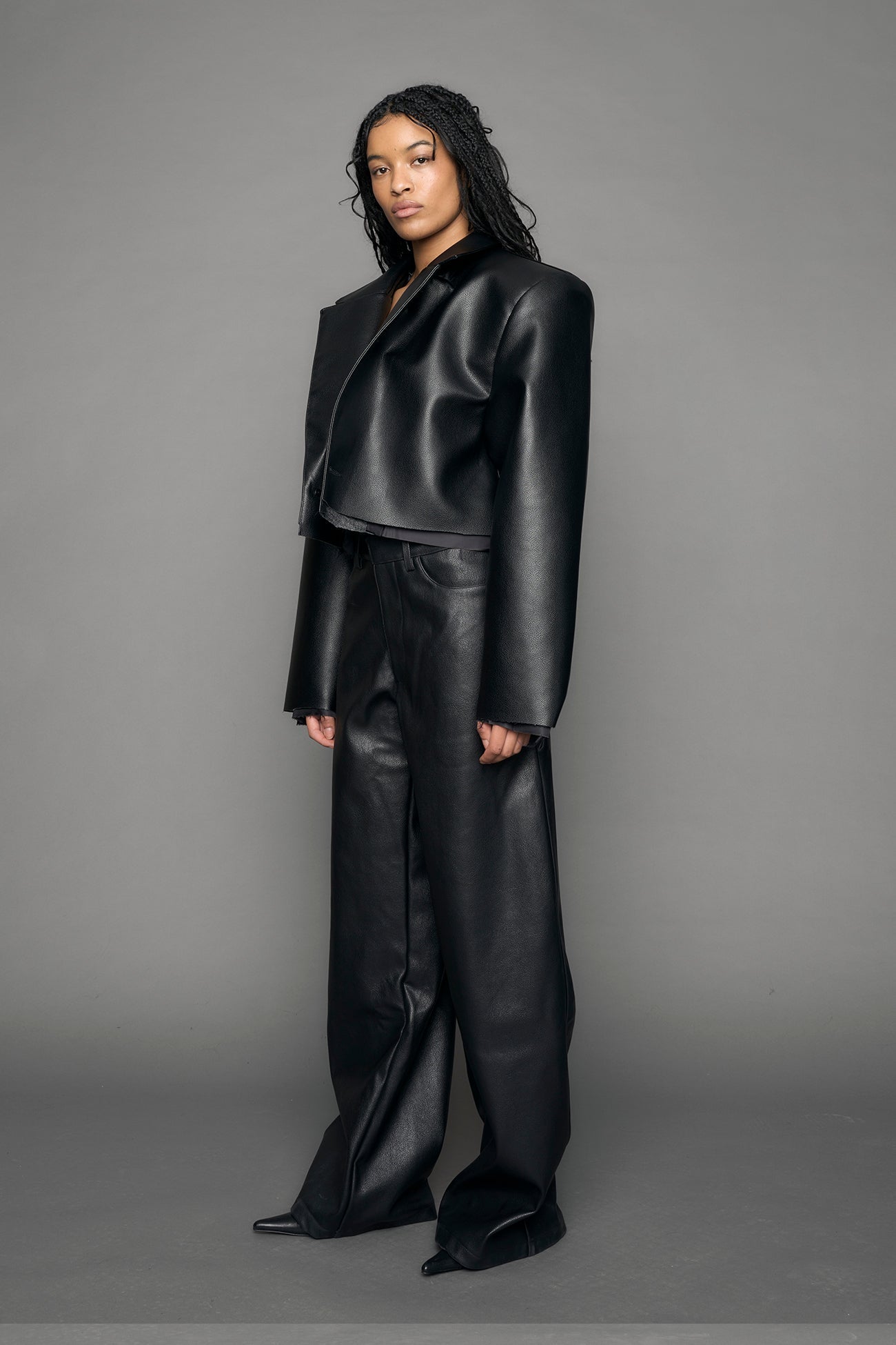 model wearing black vegan leather blazer cropped