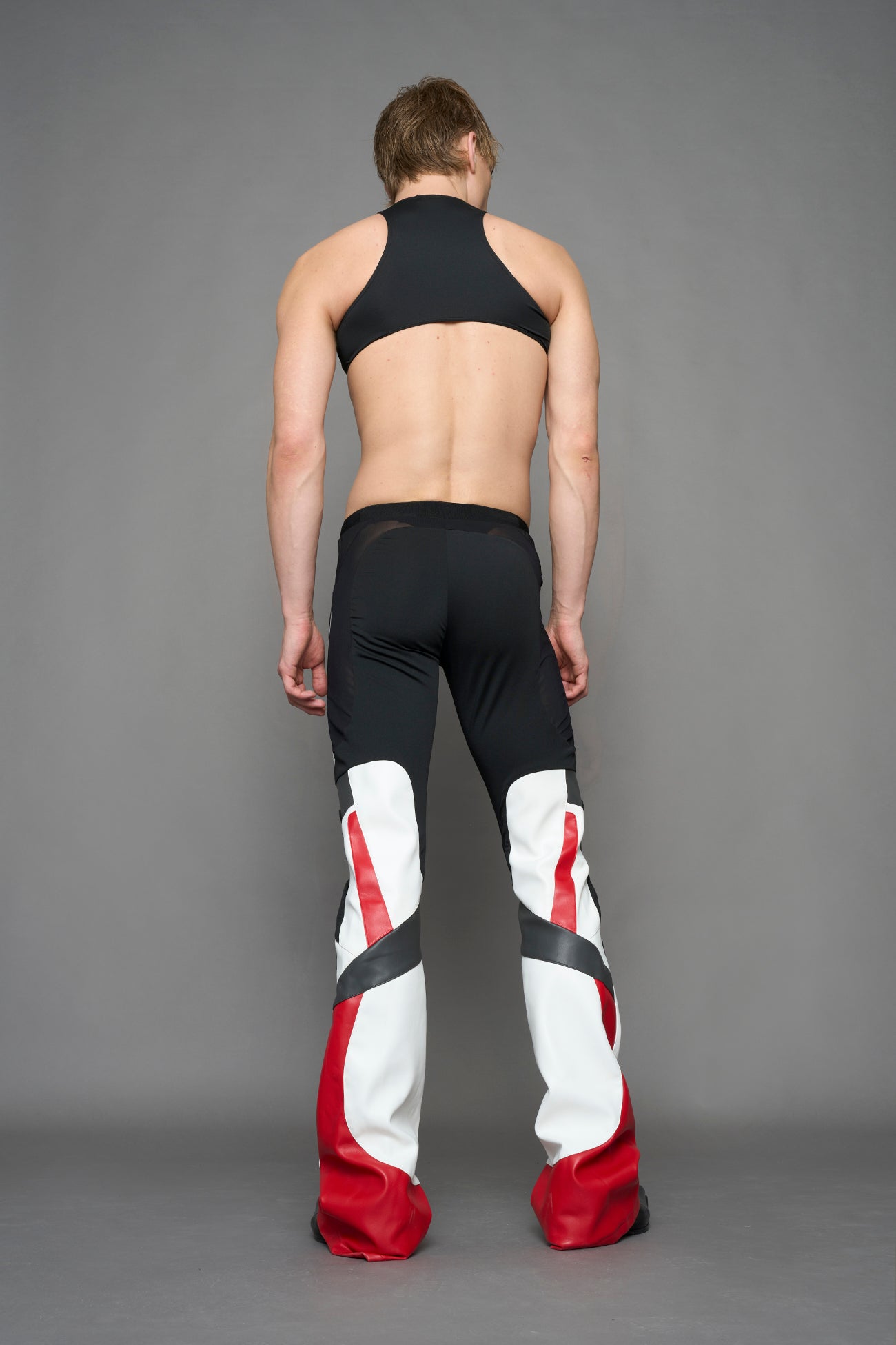 model wearing red black white moto inspired mesh pants with logo on the leg