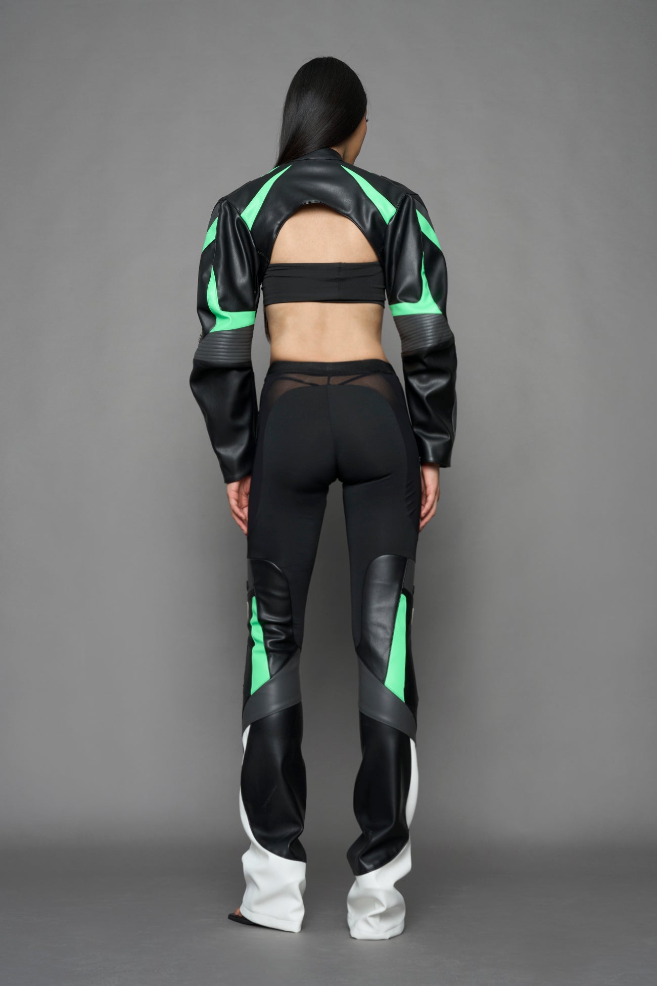 model wearing black white green moto inspired mesh pants with logo on the leg