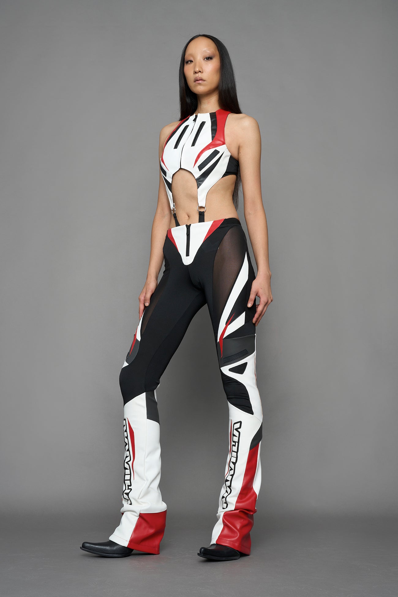 model wearing red black white moto inspired mesh pants with logo on the leg