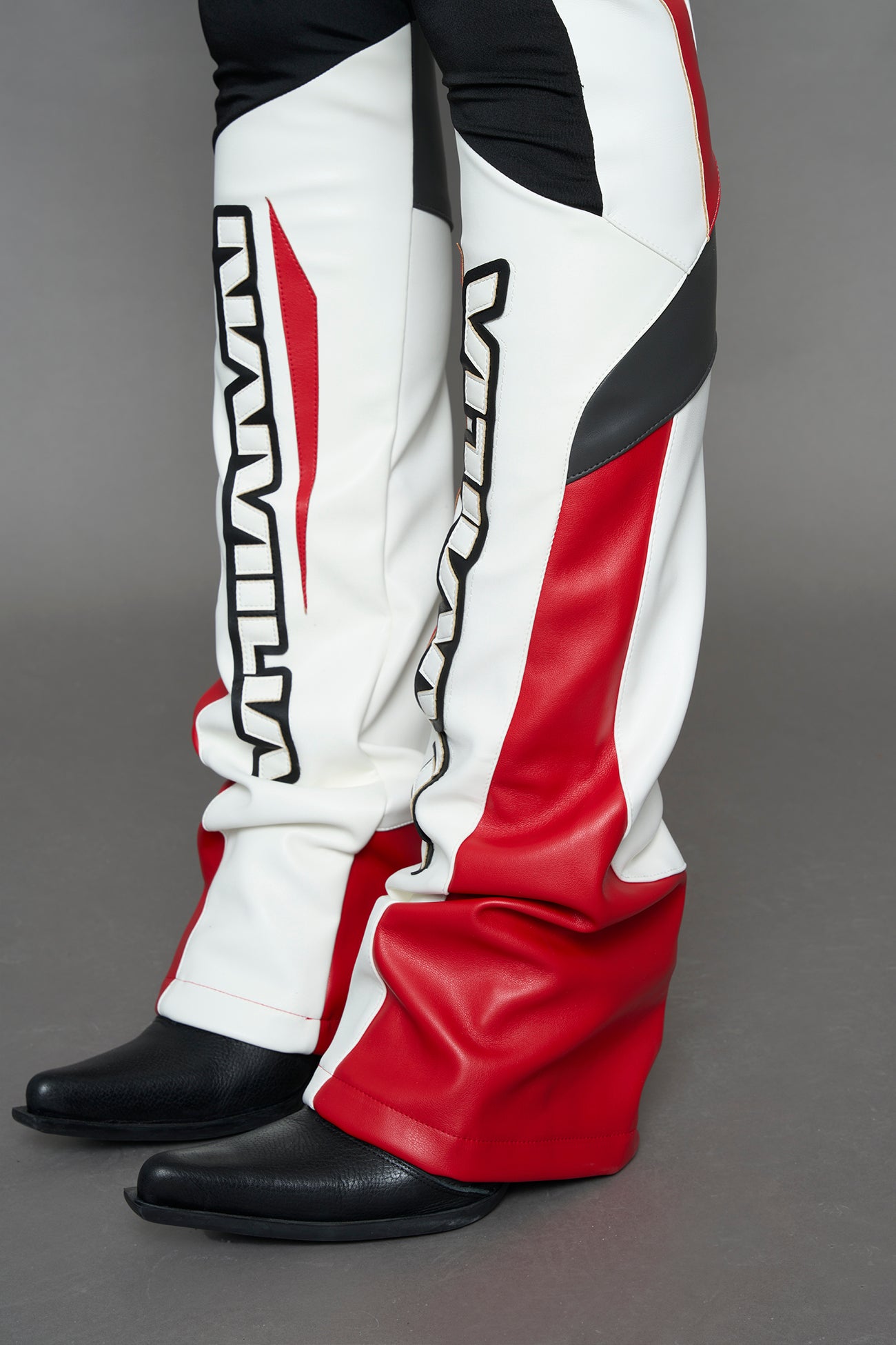 model wearing red black white moto inspired mesh pants with logo on the leg