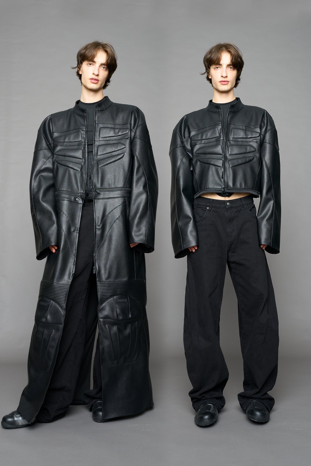 Detachable moto long coat in black vegan black leather inspired by a deconstructed full-body motocross racing suit, featuring padded panel details and a detachable zip design for two-way wear.