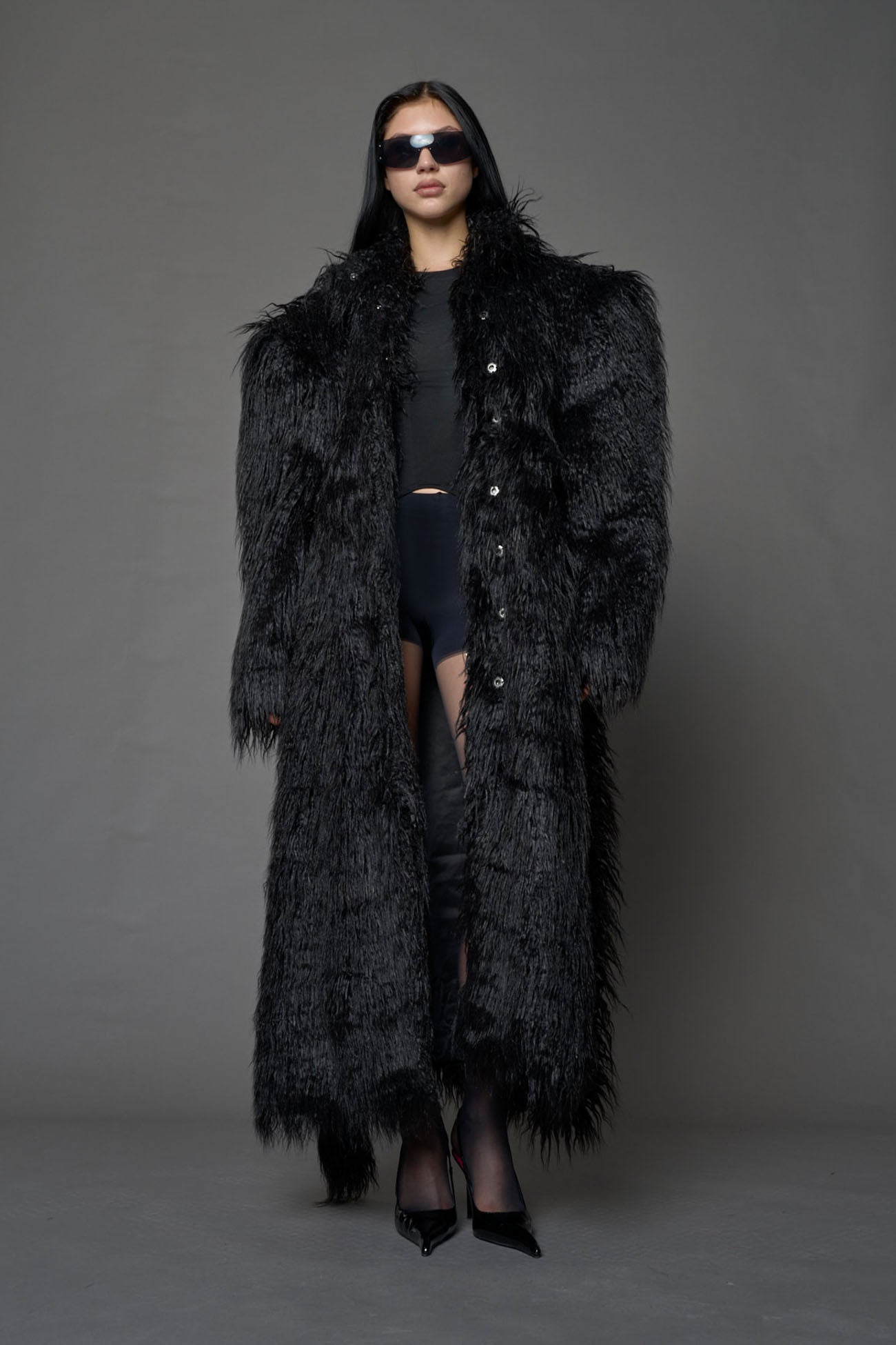 black faux fur coat with shoulder pads and belt