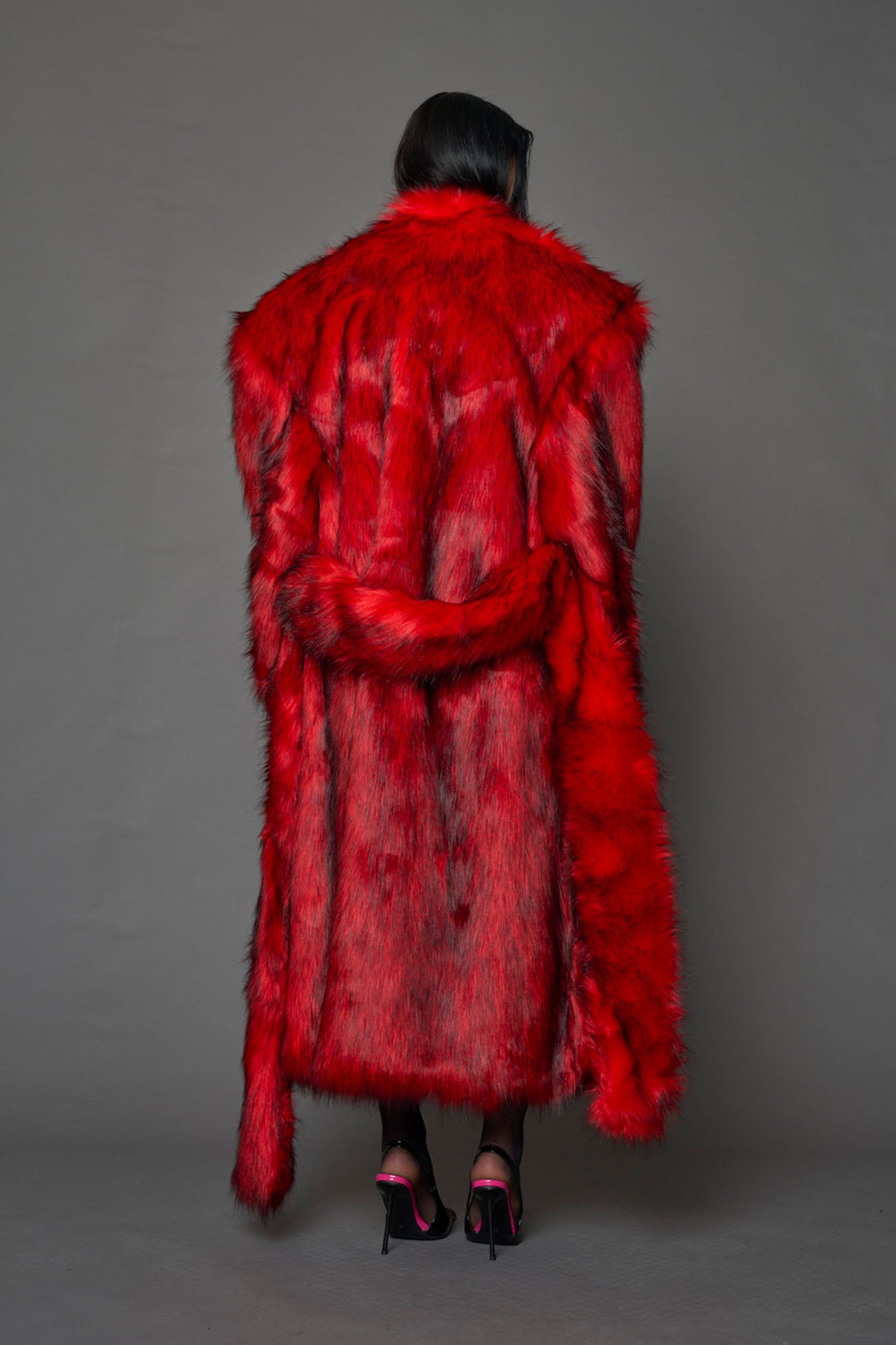 red faux fur coat with shoulder pads and belt