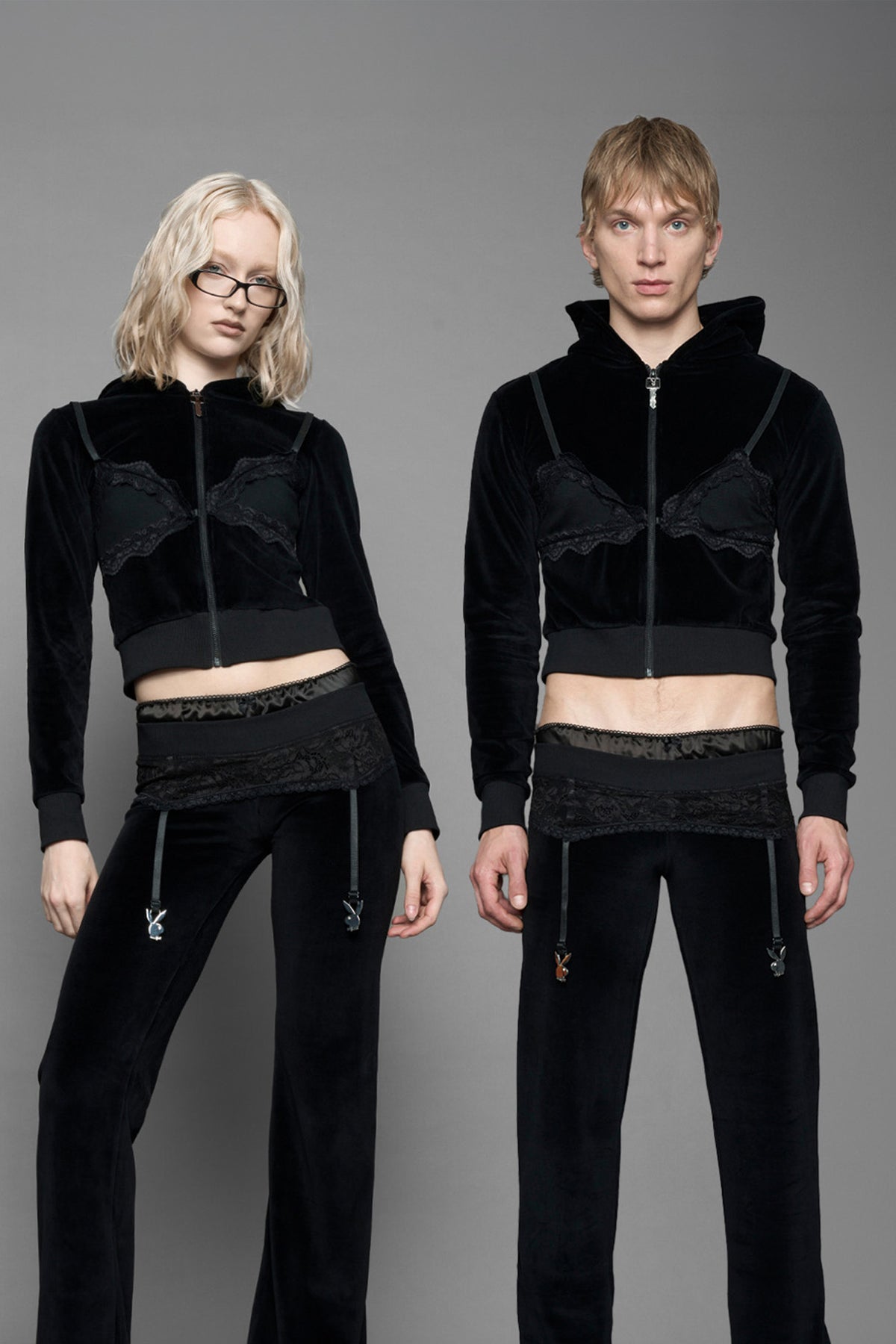 model is wearing a black velvet cropped zip-up hoodie with a black lace bralette and a Playboy branded key formed Zipper Pull