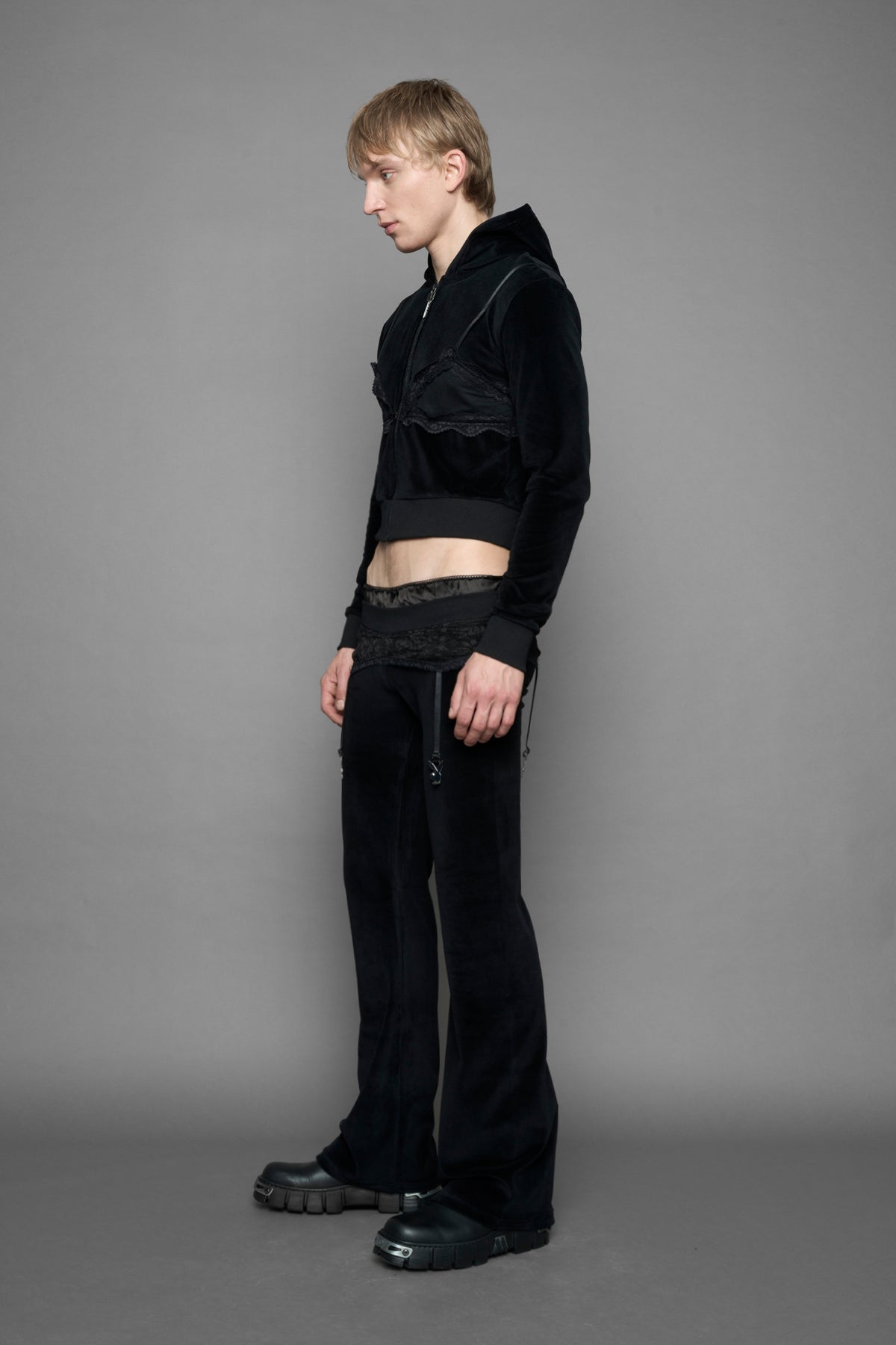 model is wearing a black velvet cropped zip-up hoodie with a black lace bralette and a Playboy branded key formed Zipper Pull