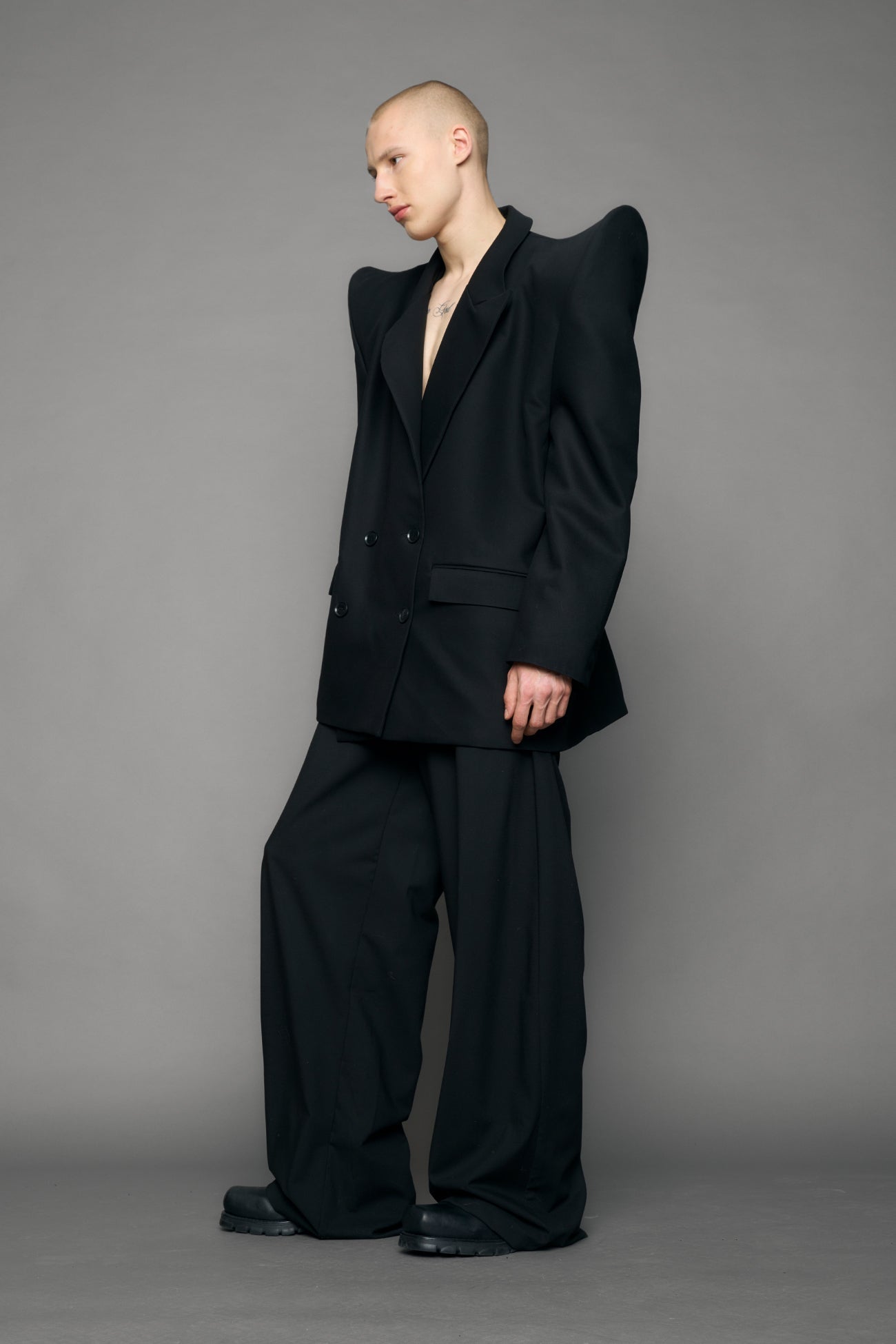 model wearing black blazer with sharp shoulder design