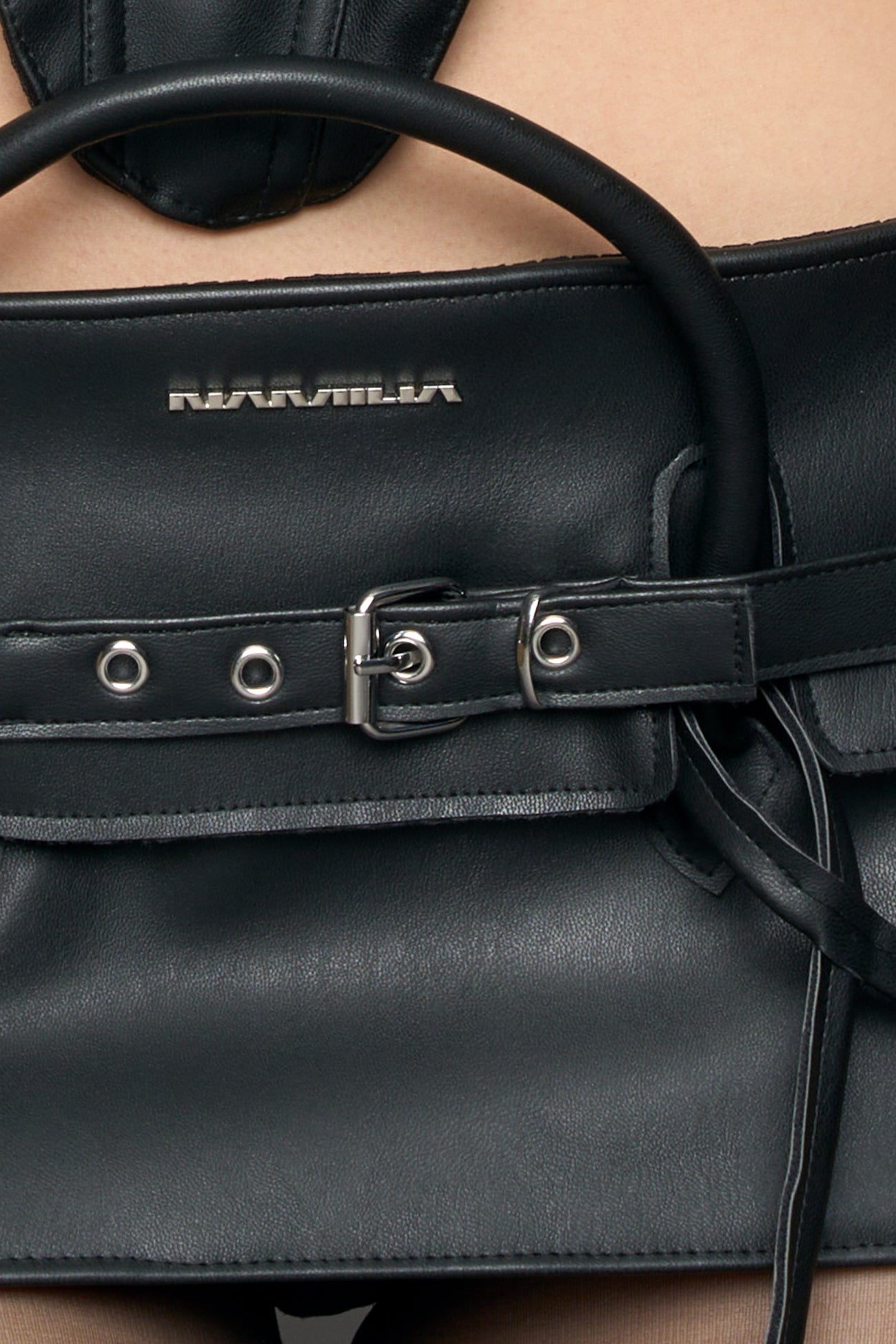 model wearing black pu leather handbag skirt