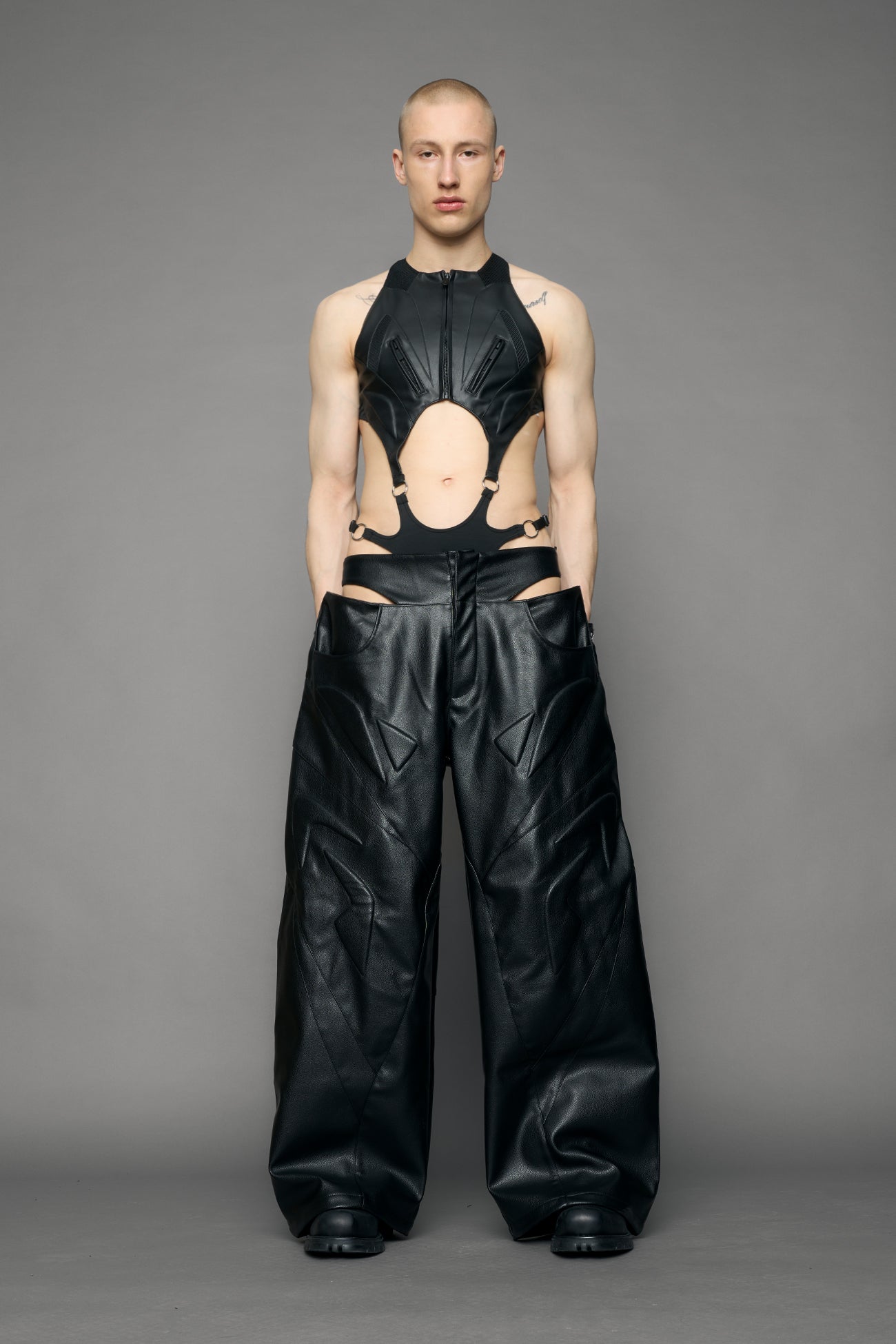 model wearing black pu leather trousers with thong design and moto style highlights