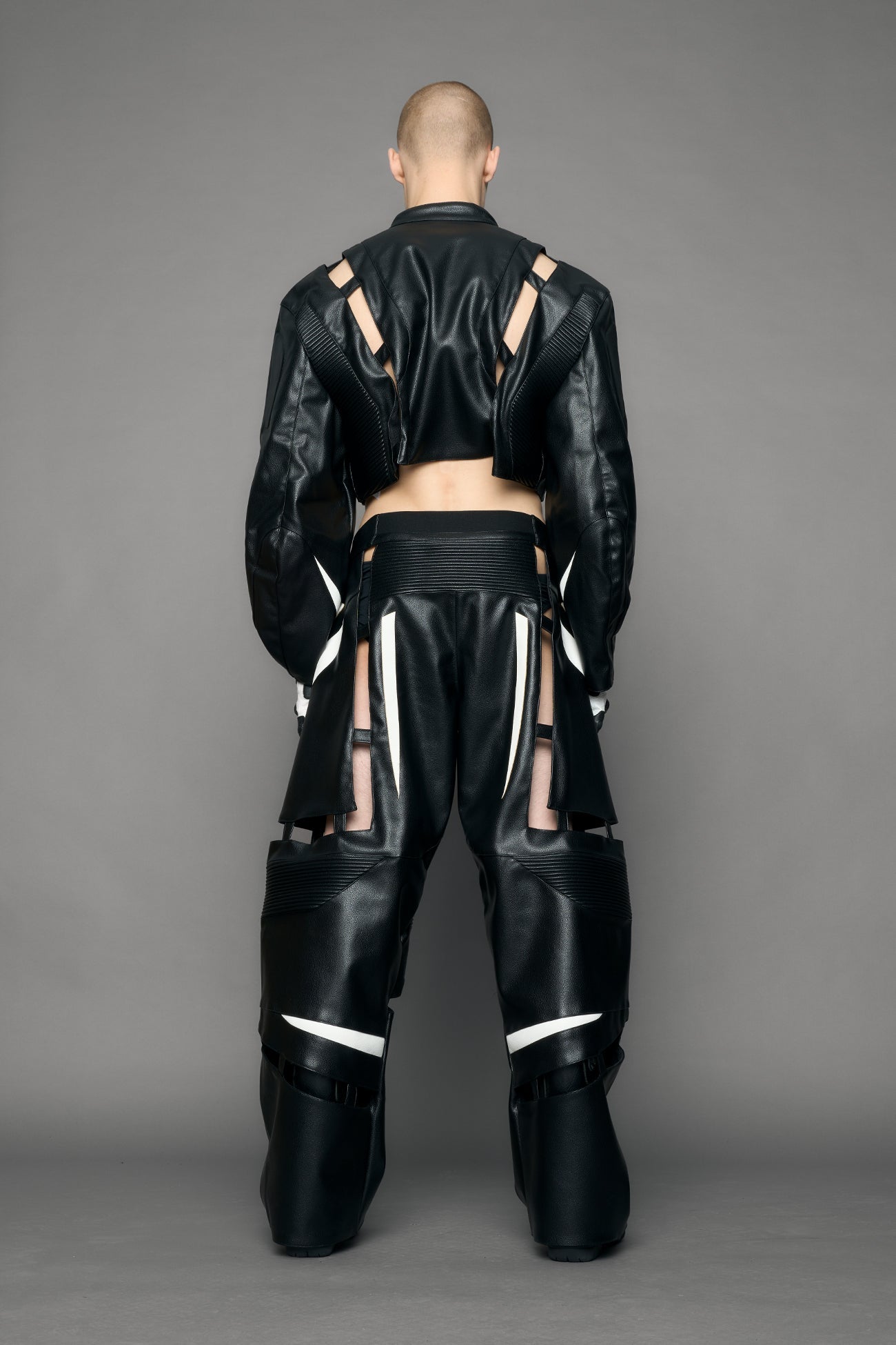 model wearing black and white pu leather pants with cut out details