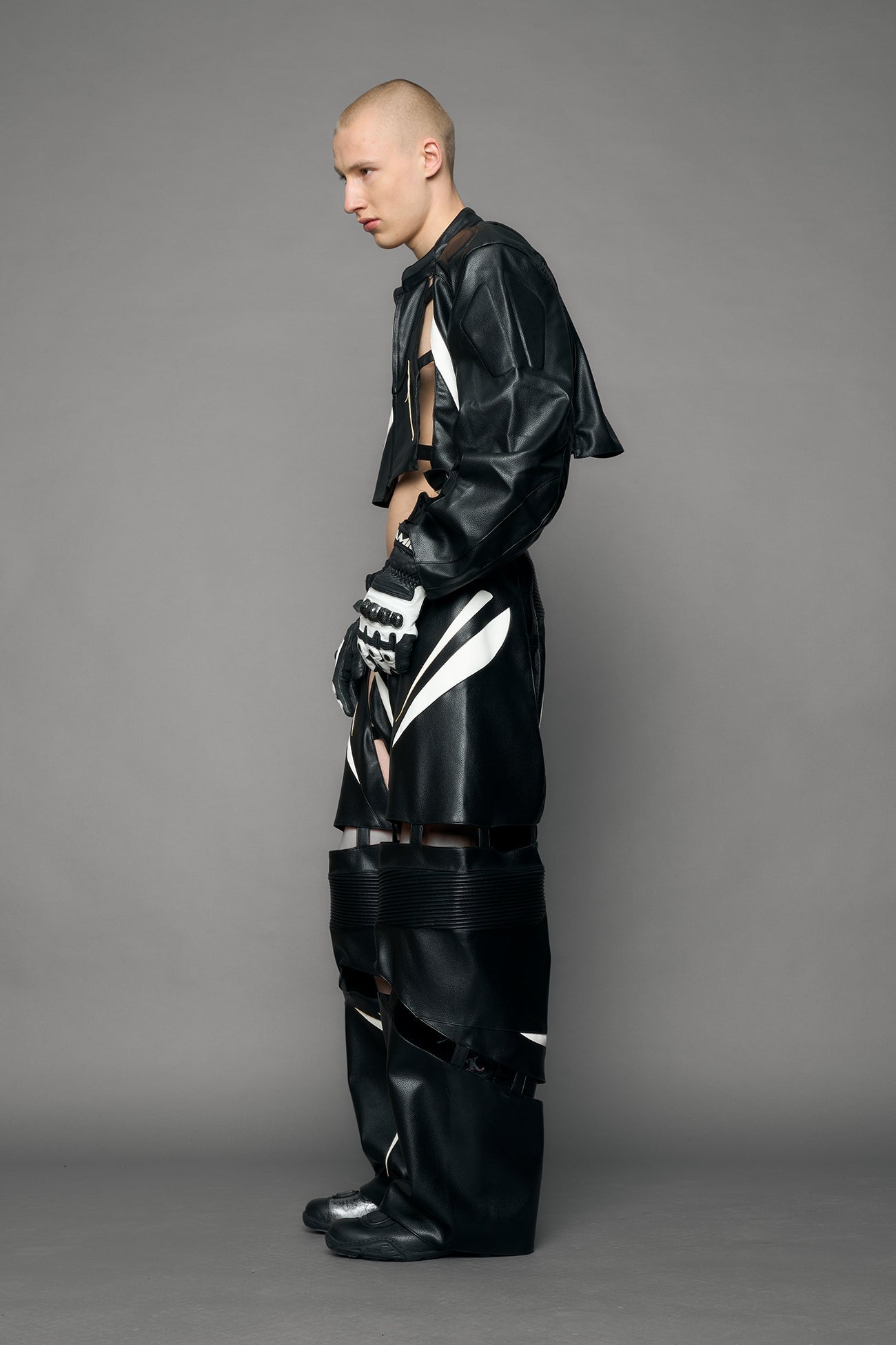 model wearing black and white pu leather pants with cut out details