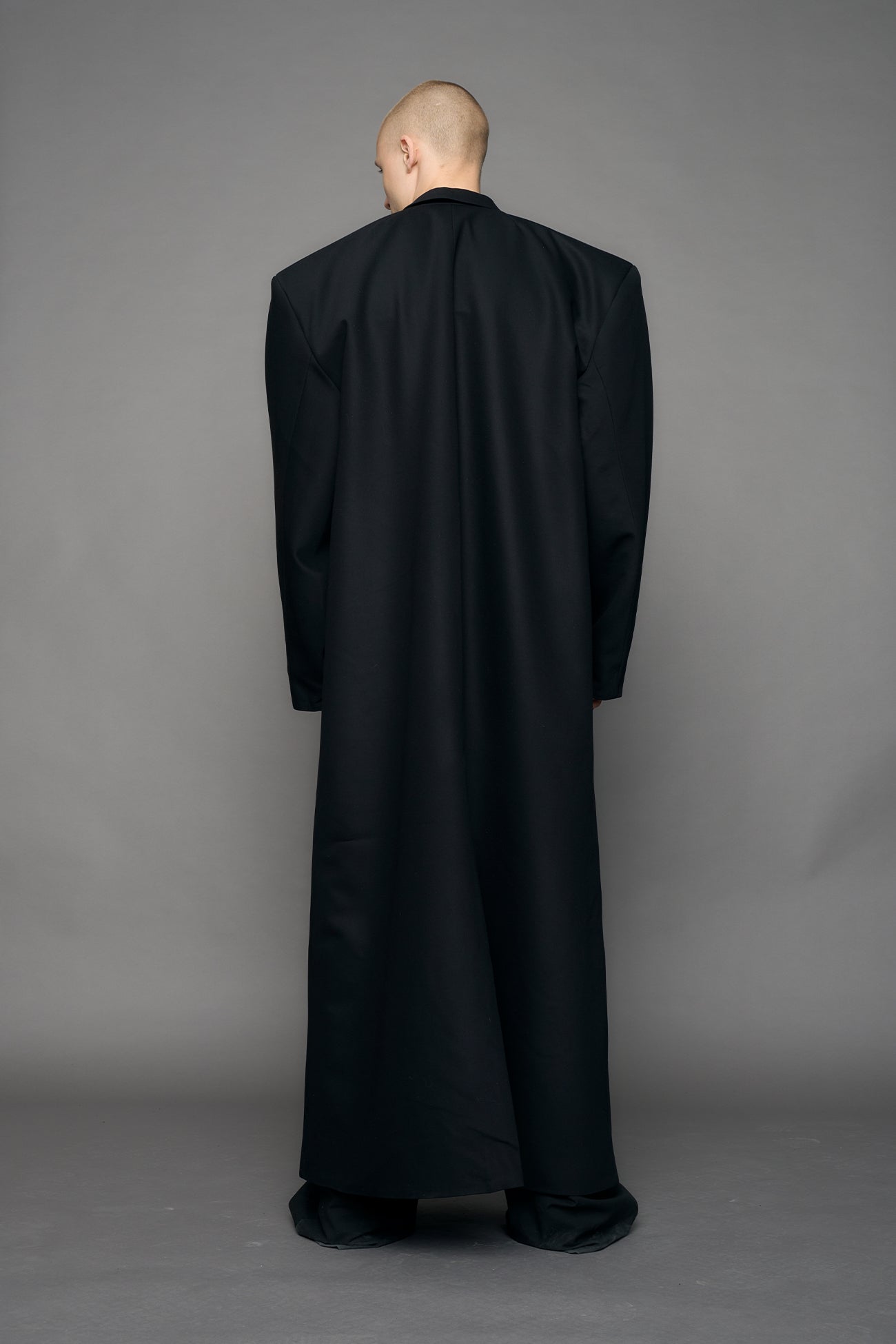 long blazer coat in black wool with exagerated shoulders and lapel