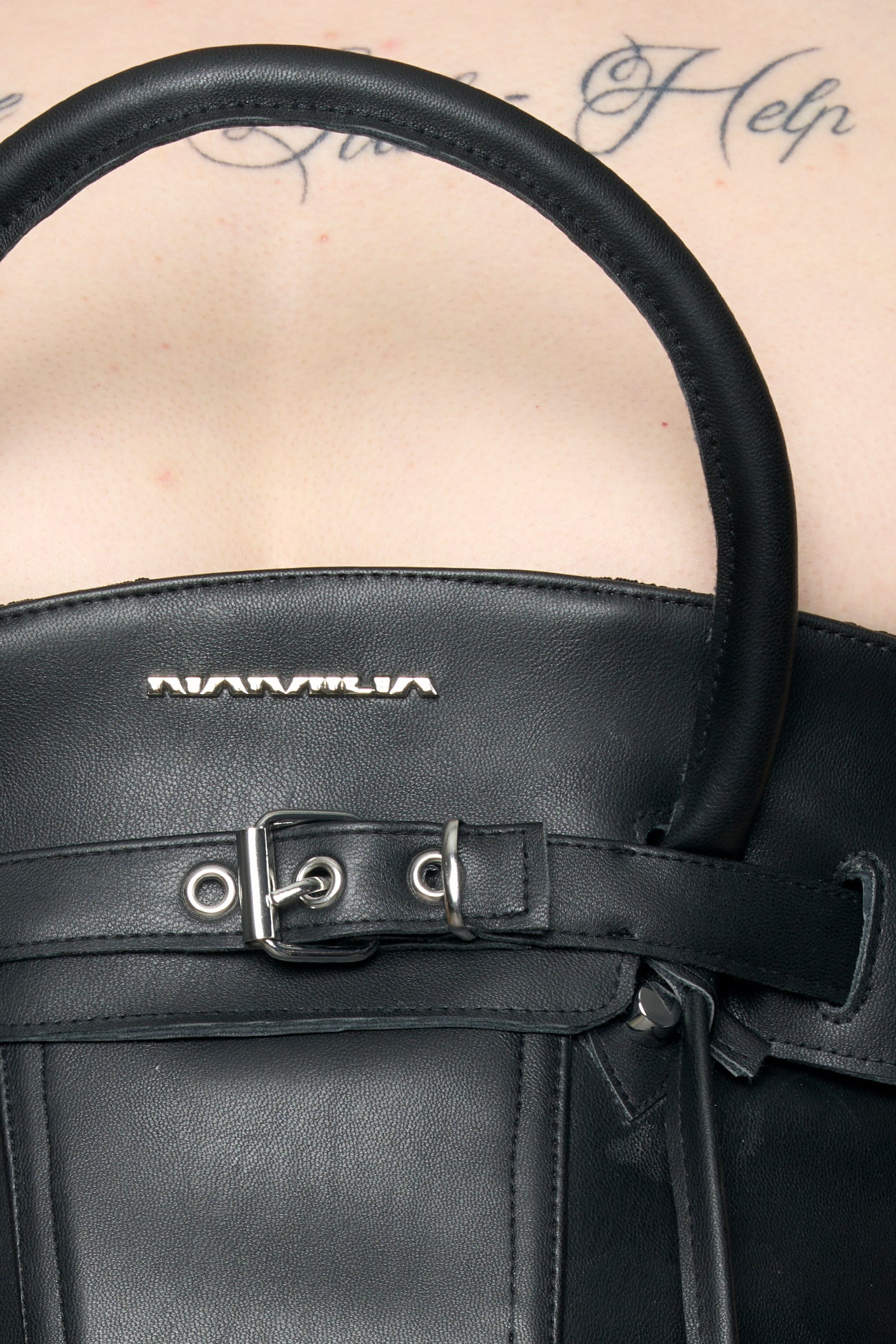 model wearing black pu leahter corset with handbag design 
