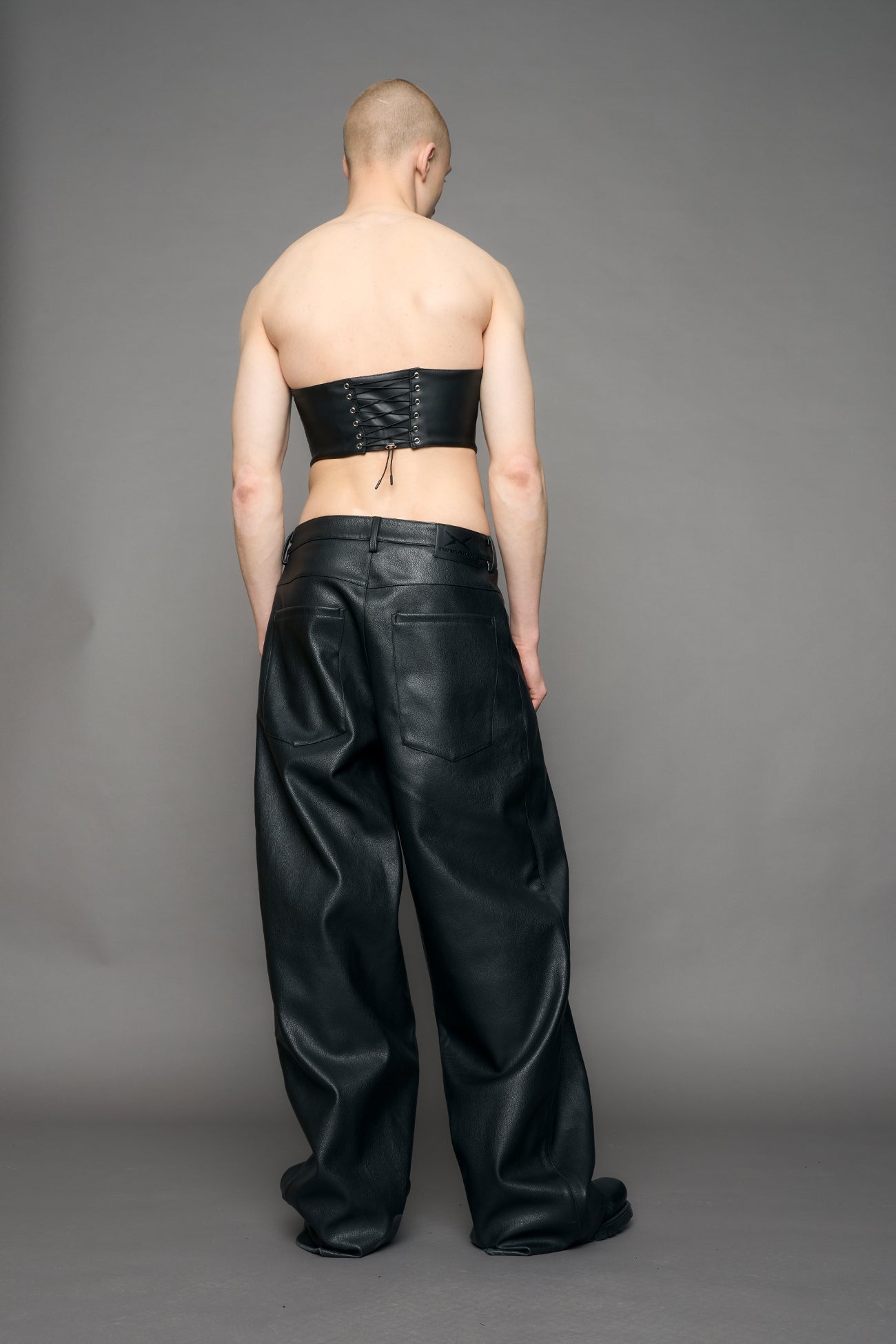 model wearing black studded handbag corset 