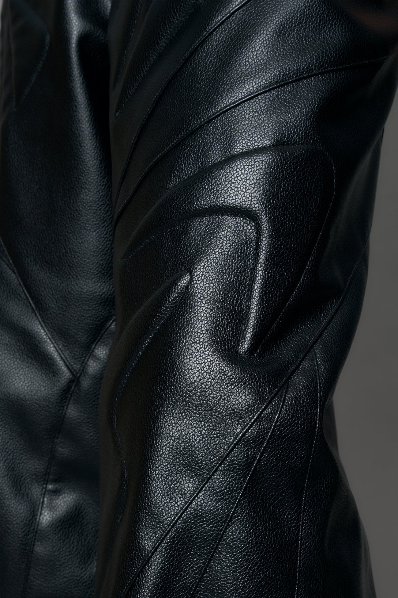 model wearing black pu leather trousers with thong design and moto style highlights