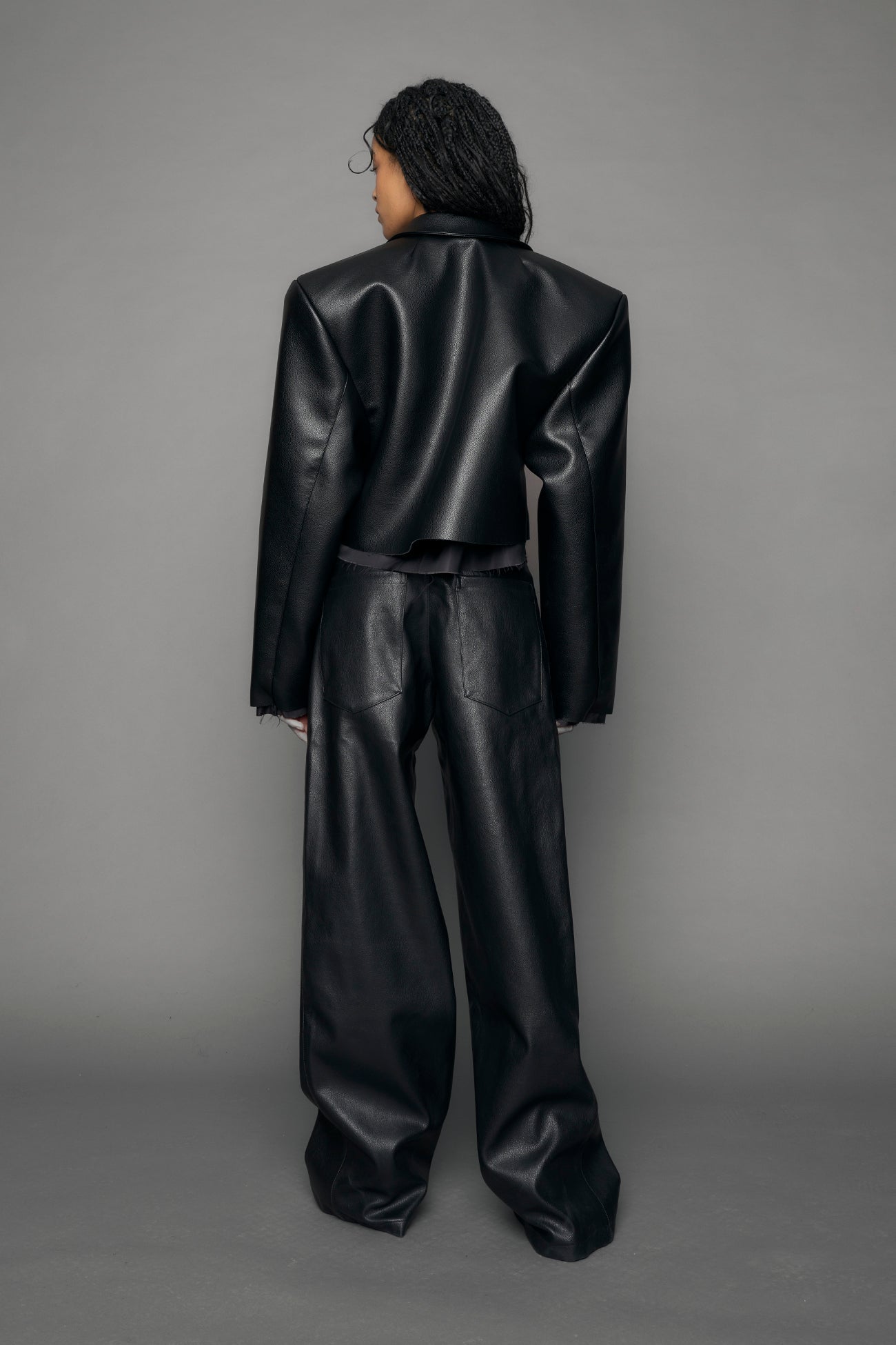 model wearing black vegan leather blazer cropped