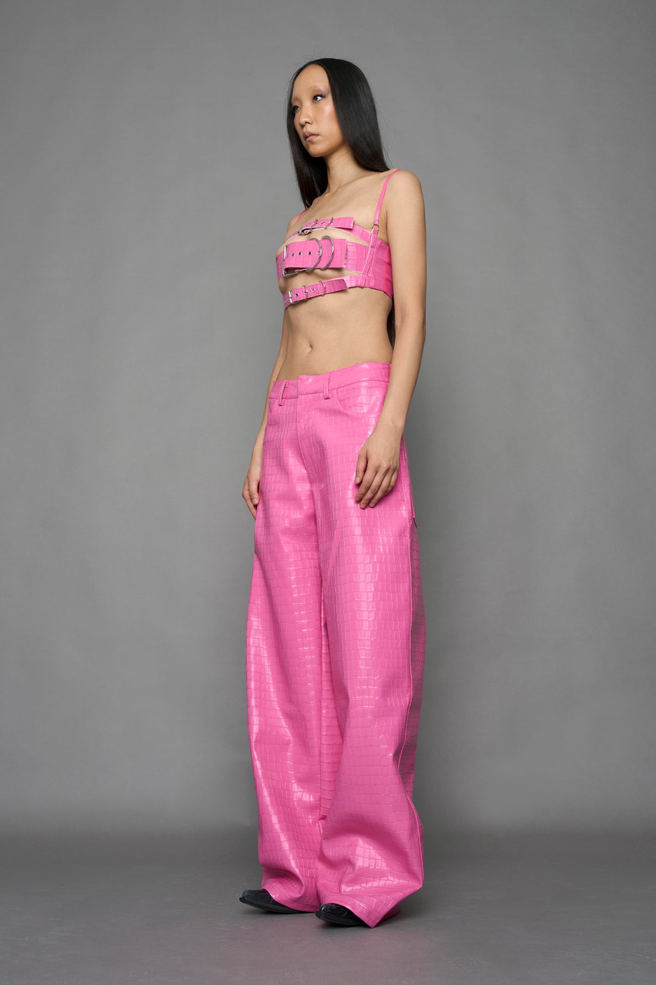 model wearing pink vegan leather croc baggy pants
