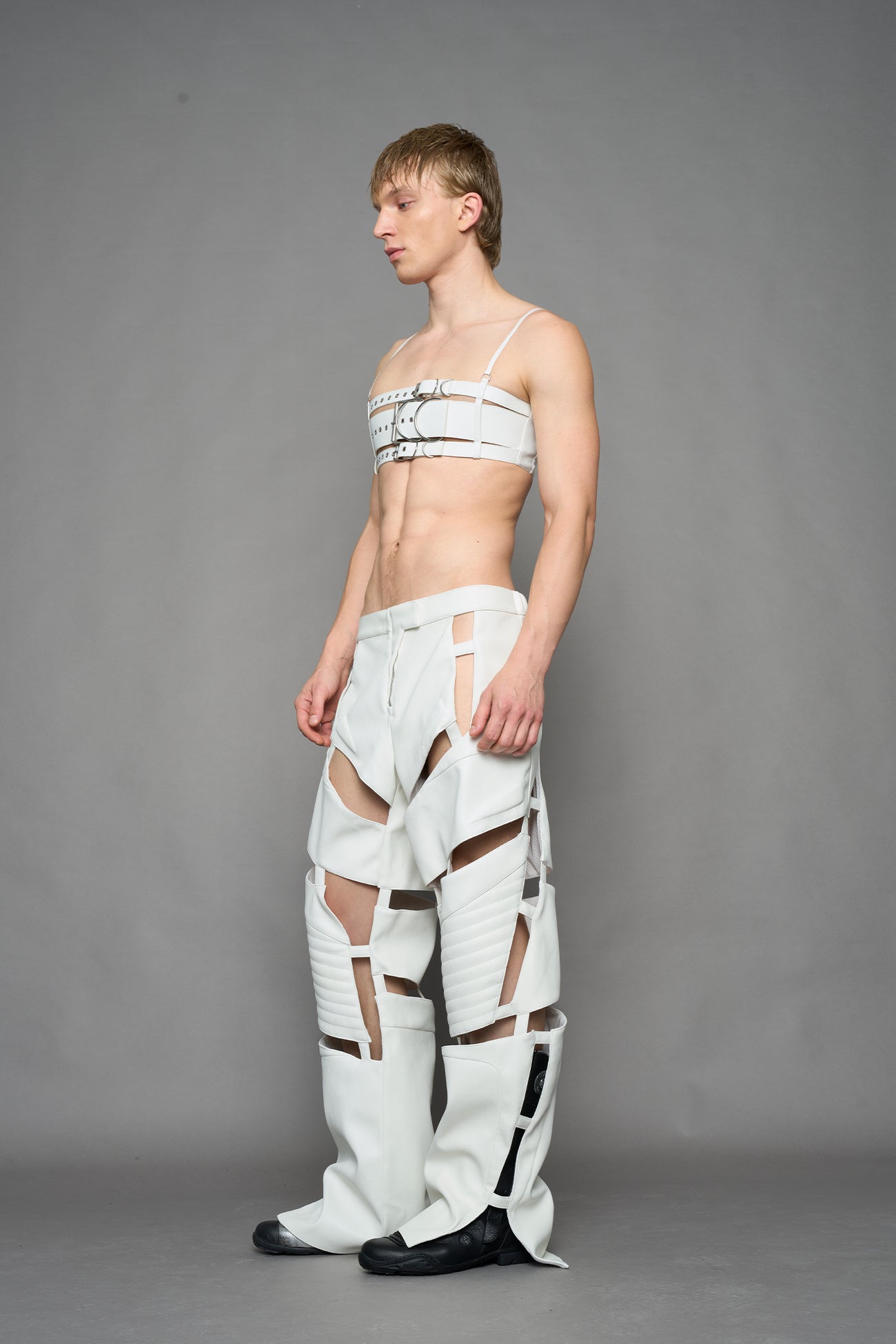 model wearing white vegan leather pants with cut out details