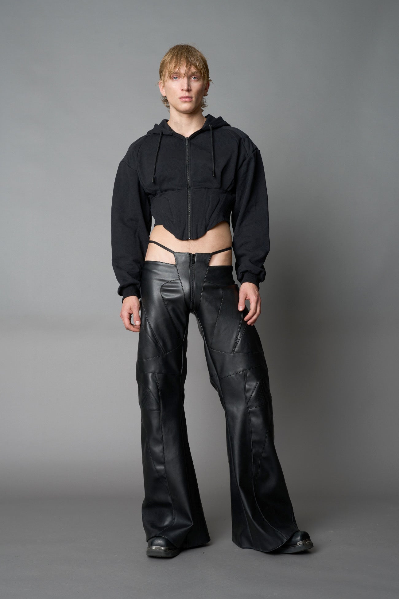 model wears black oversize hoodie with integrated corset