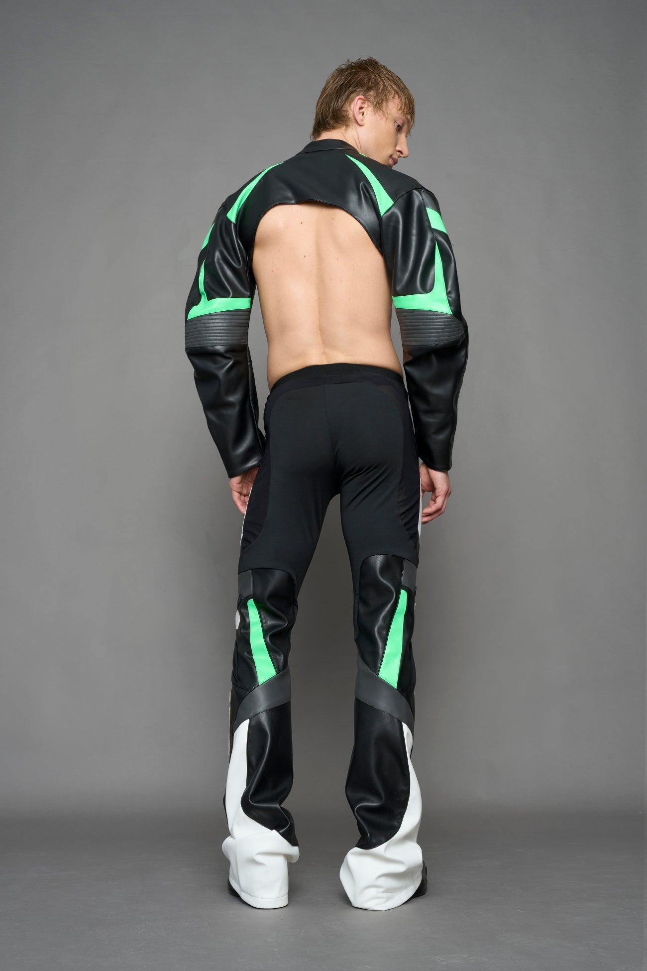 model wearing black white green moto inspired mesh pants with logo on the leg