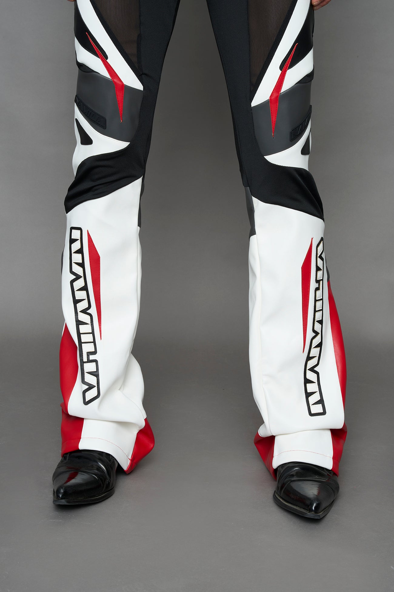 model wearing red black white moto inspired mesh pants with logo on the leg