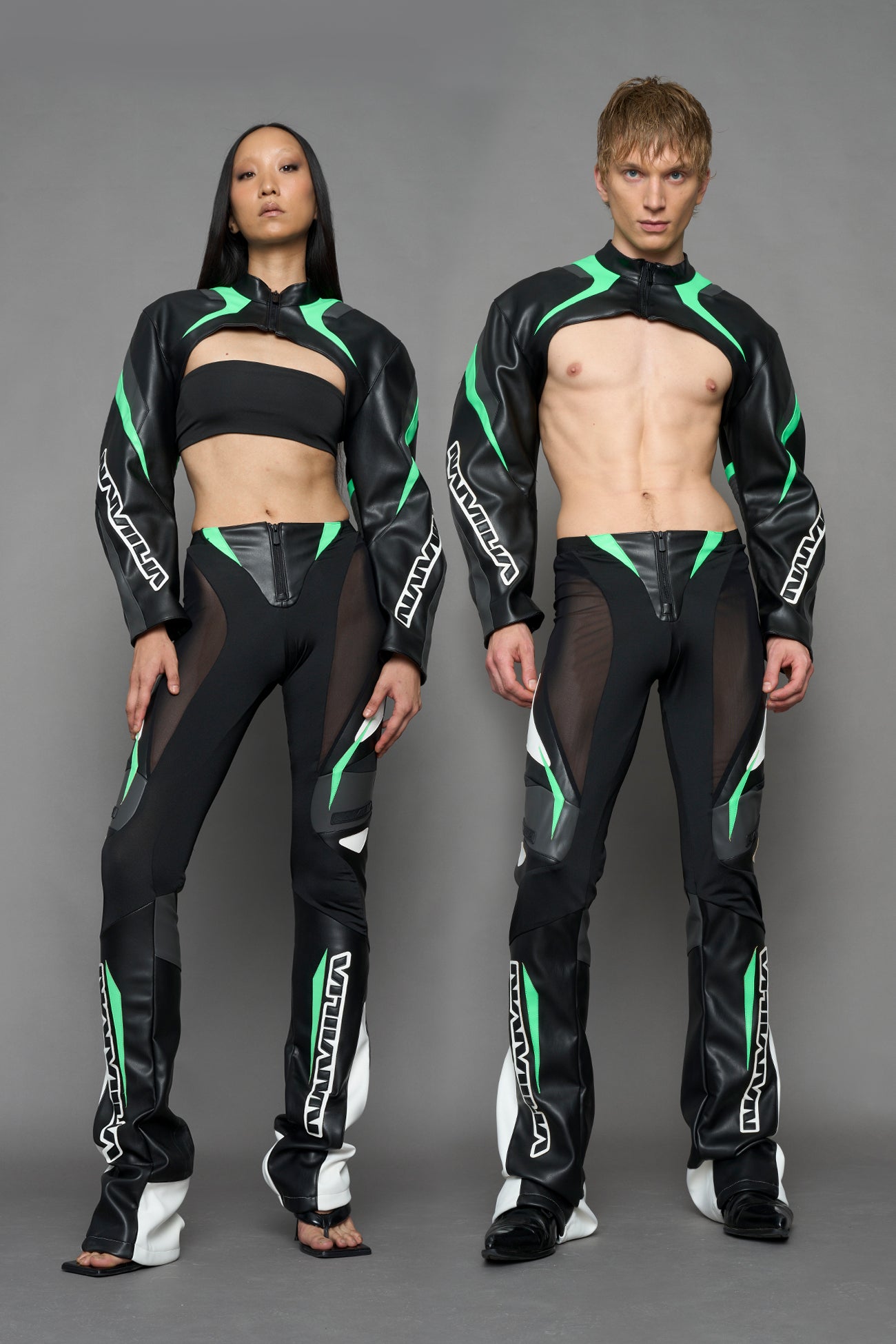 two models wearing black white green moto inspired mesh pants with logo on the leg