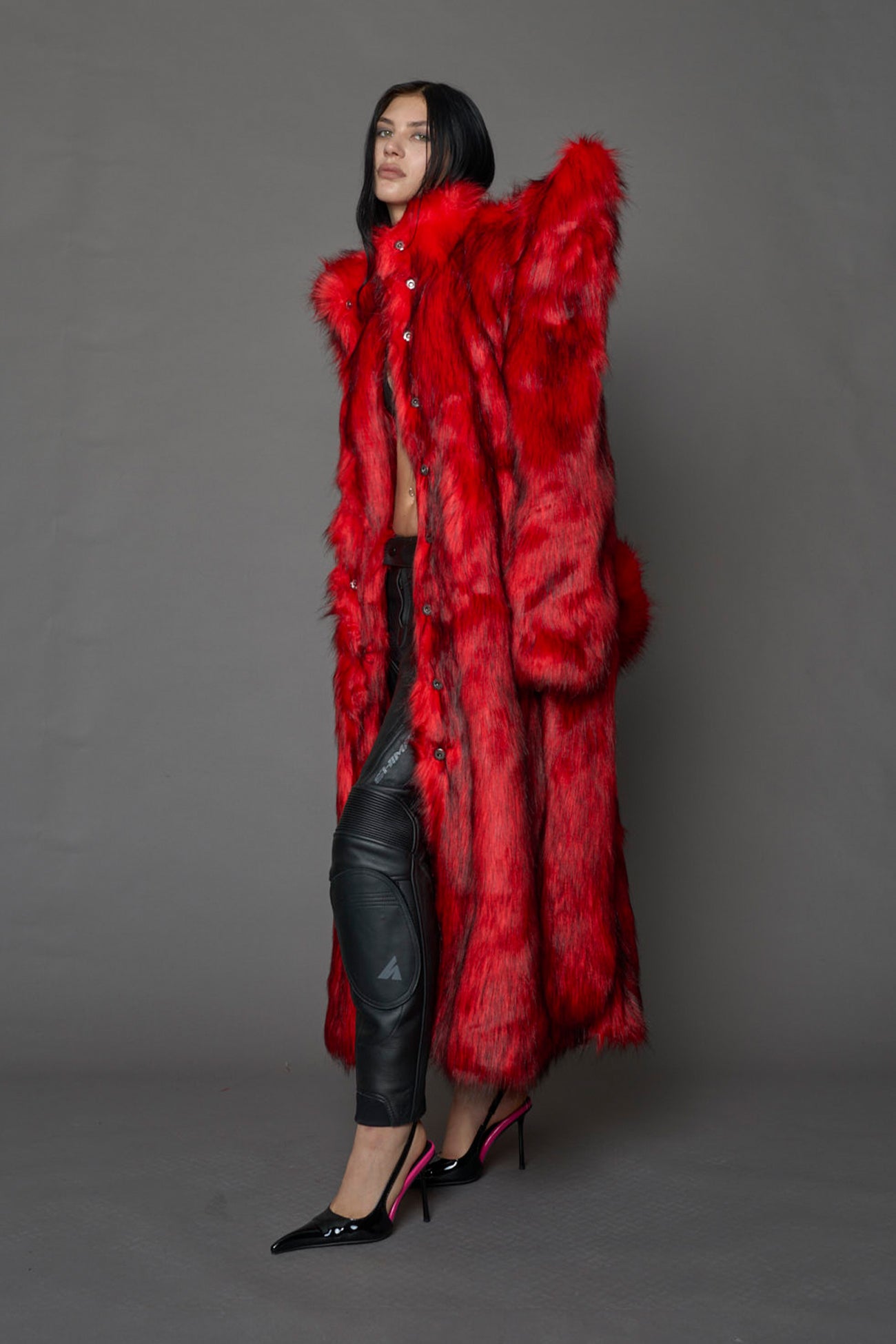 model wearing red spike shoulder long faux fur coat