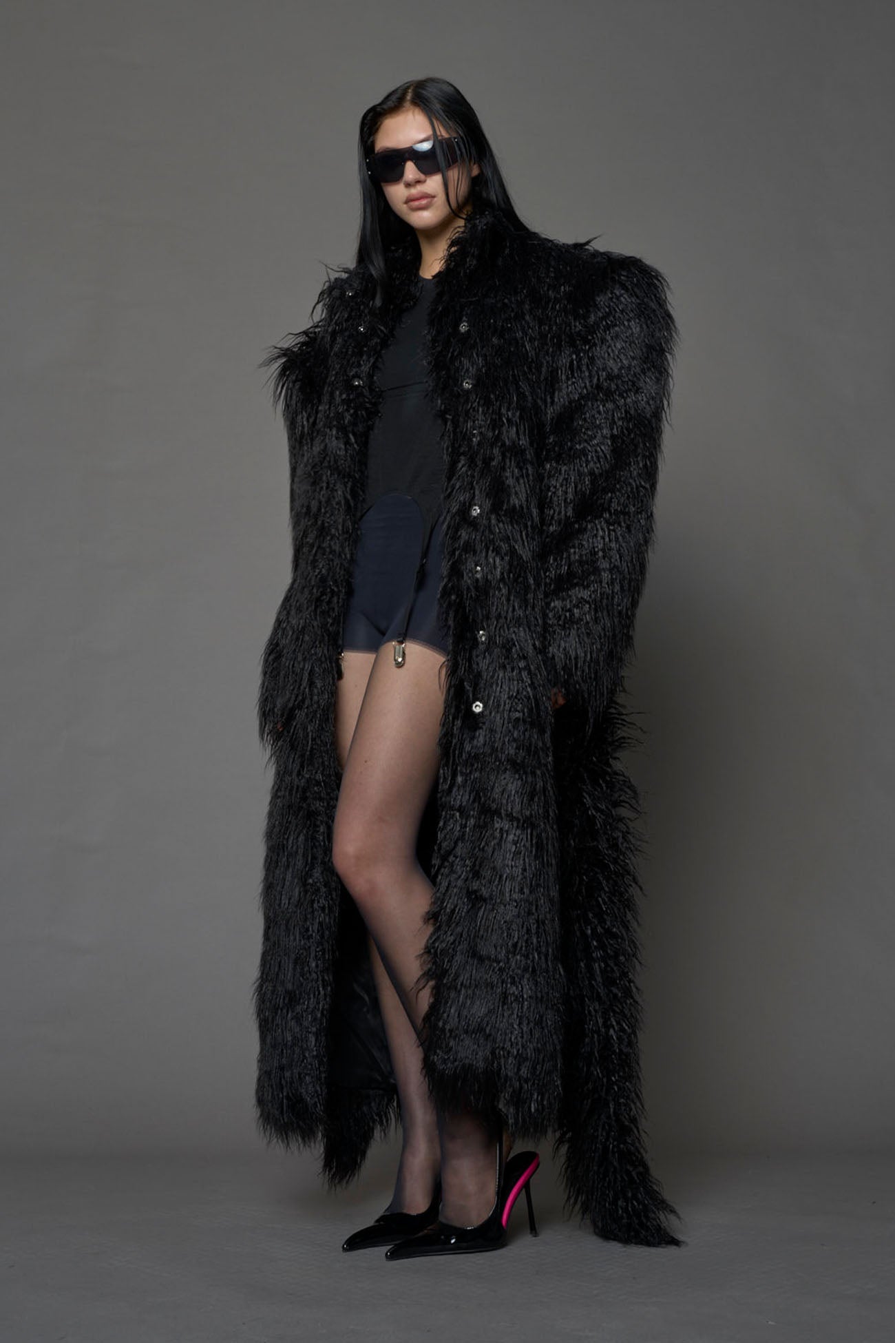 black faux fur coat with shoulder pads and  belt