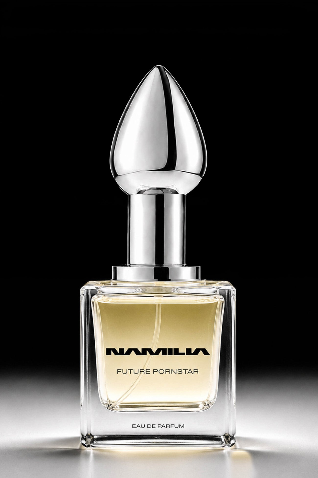 A bottle of Namila  Eau de Parfum with a large reflective plug-shaped cap